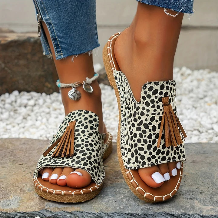 Comfortable women's patterned open toe flat slide sandals featuring stylish tassels. Ideal casual summer shoes.