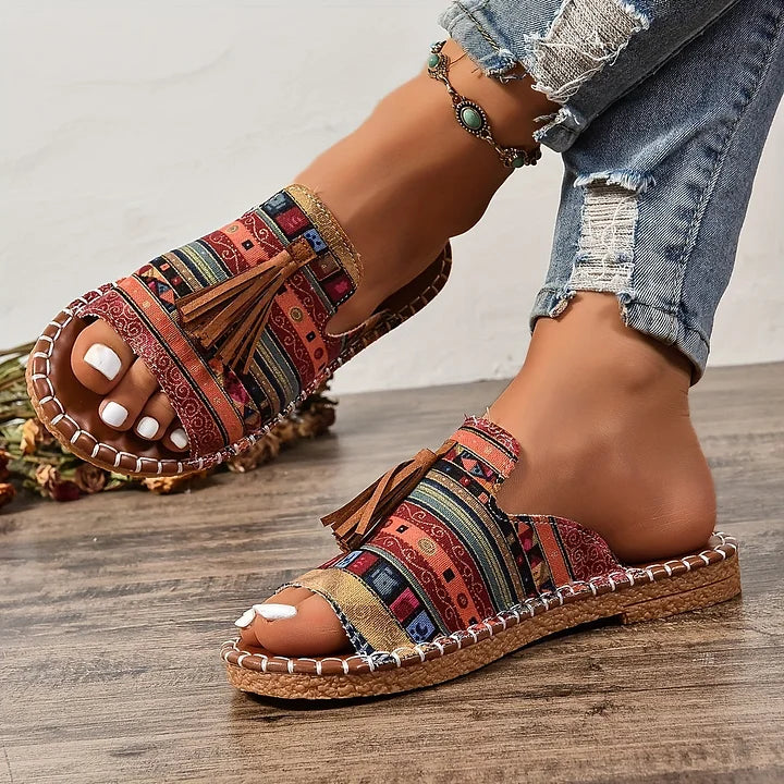 Versatile women's patterned open toe tassel slide sandals. Comfortable flat sole, ideal for beach & casual summer.
