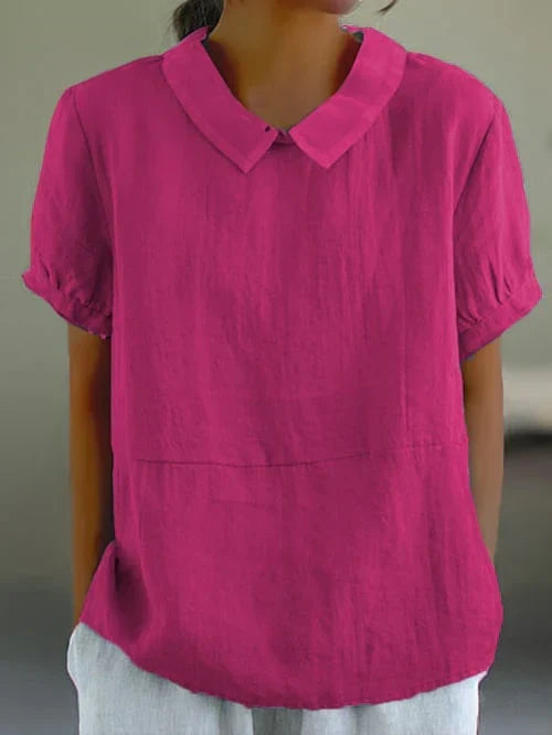 Charming short-sleeve women's blouse with Peter Pan collar and relaxed fit, great for warm weather.
