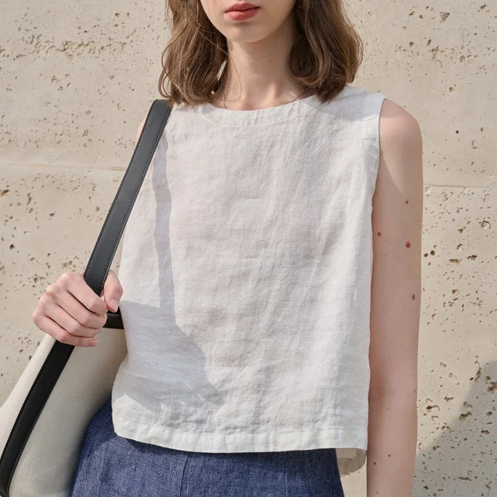 Stylish women's asymmetric crop top, sleeveless with a crew neck, ideal for casual summer wear.