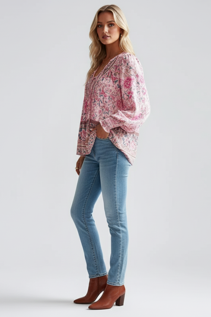 Back view of a women's loose fit floral blouse. Comfortable long sleeve top, essential for casual feminine style.