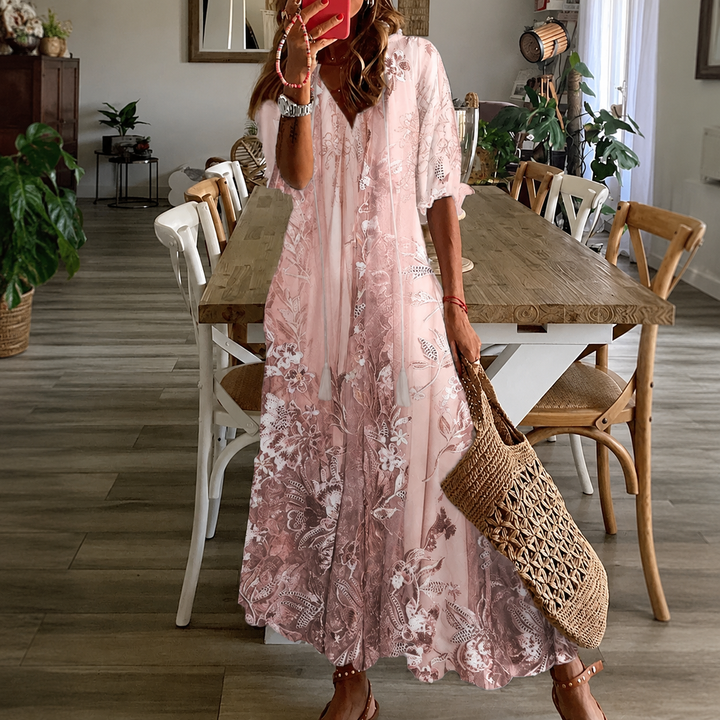 Women's pink floral print maxi dress with half sleeves & split neck, perfect for summer garden parties.