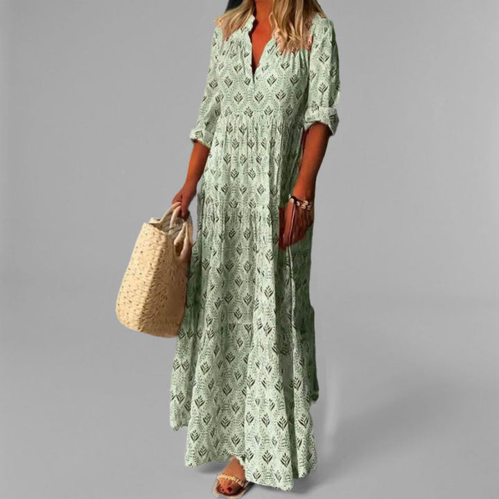Comfortable blue V-neck tiered maxi dress for women, with a flowing silhouette. Ideal for casual or elegant summer wear.