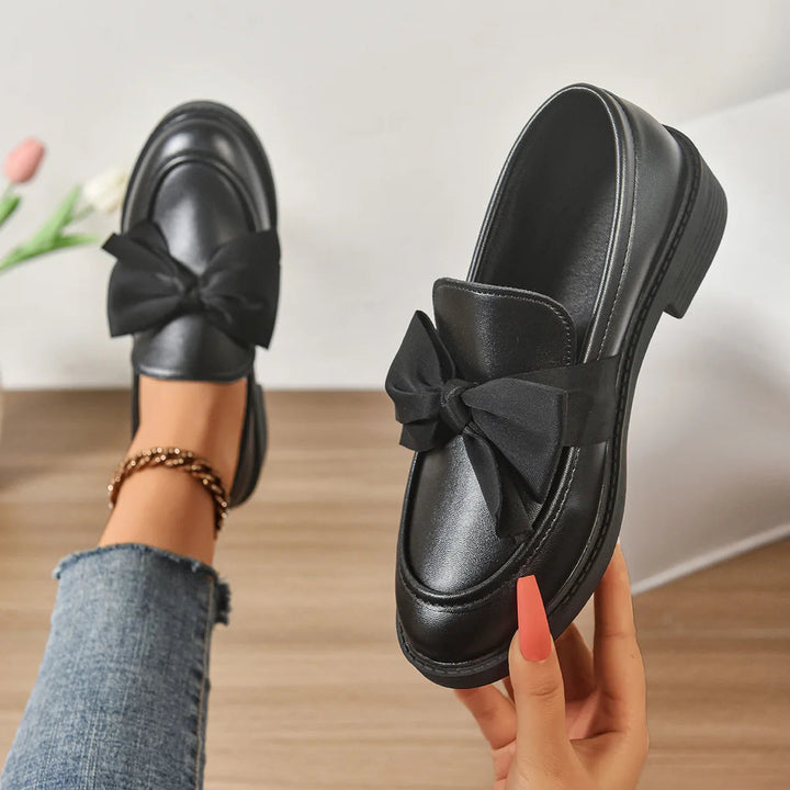 Comfortable women's loafers featuring orthopedic arch support, a stable block heel, & easy slip-on design.