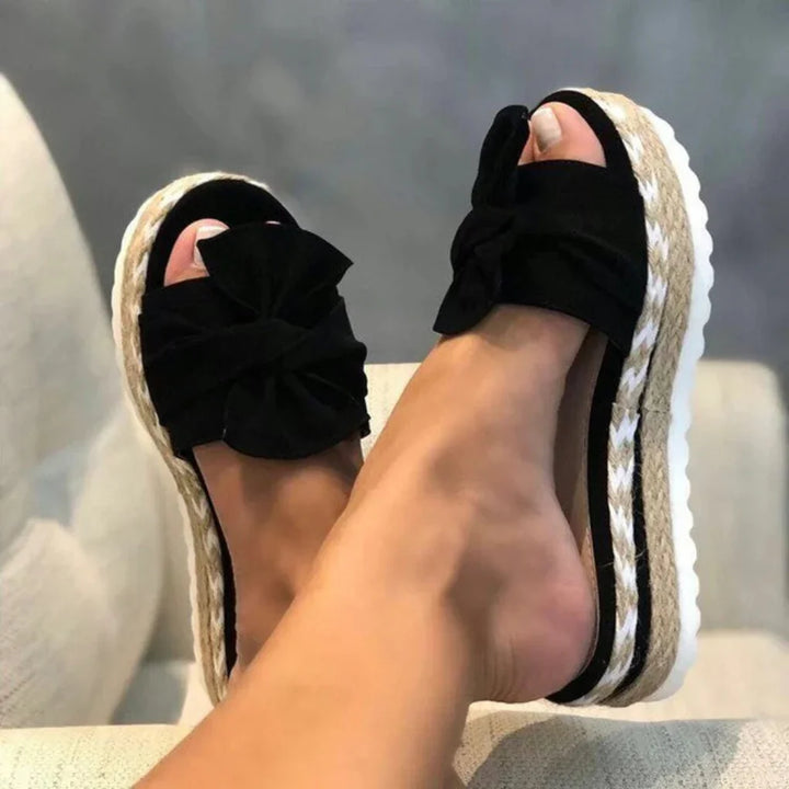 Comfortable women's platform slide sandals with a chic bow detail, ideal for spring fashion.