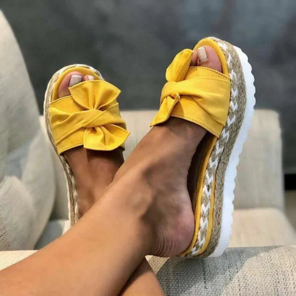Casual women's platform bow slides, offering comfort and style for warm weather.