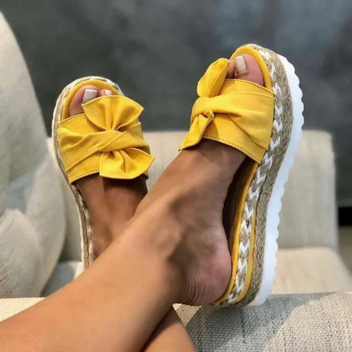 Casual women's platform bow slides, offering comfort and style for warm weather.