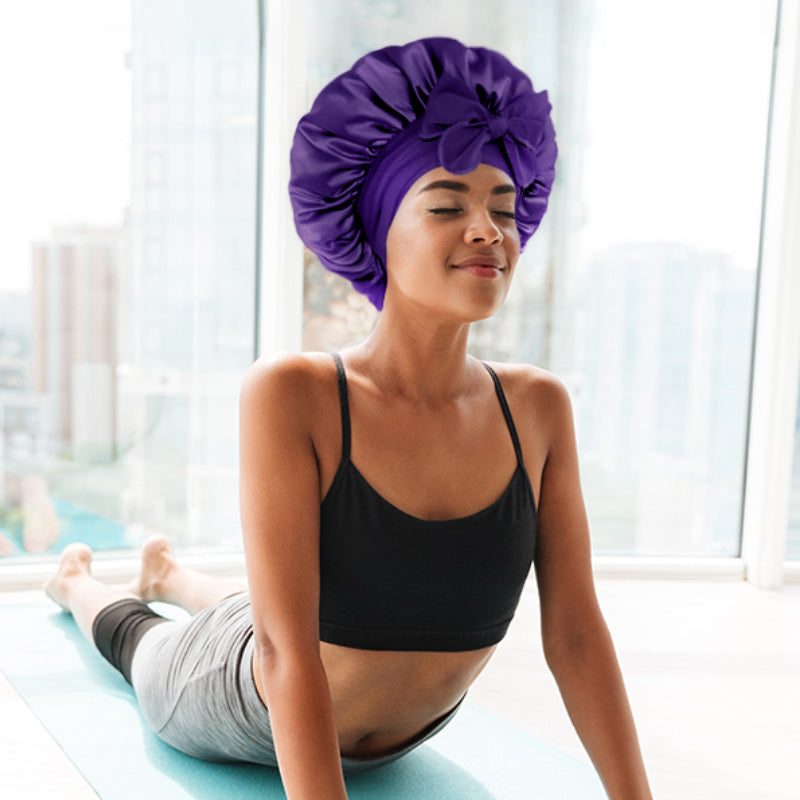 Soft pink adjustable satin bonnet for women's hair protection, prevents breakage