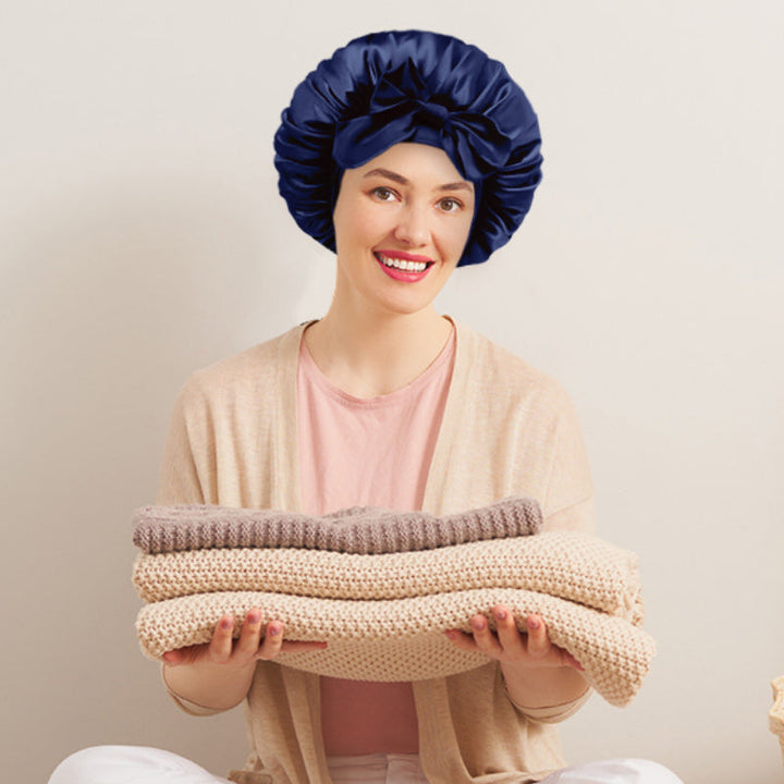 Unfolded view of a reversible women's satin bonnet, showcasing its comfortable design