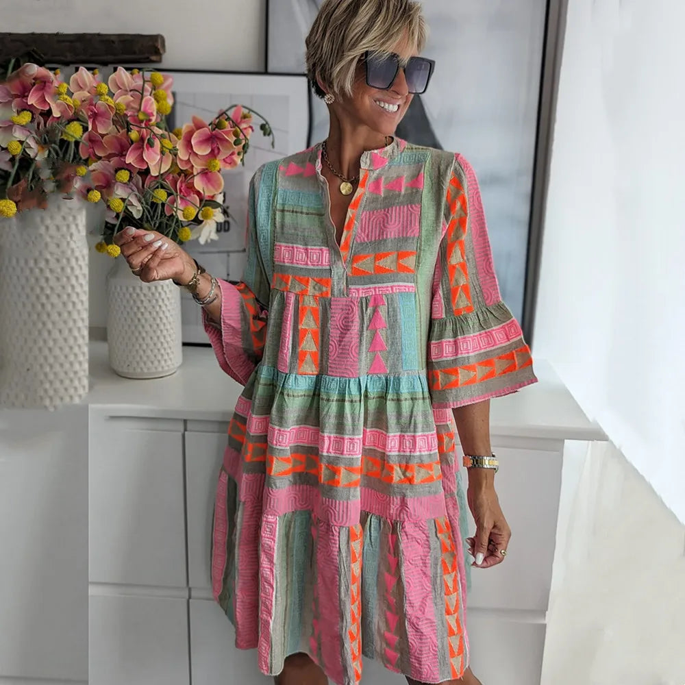Women's pink tiered mini dress with V-neck and 3/4 sleeves, perfect for spring casual or party wear.