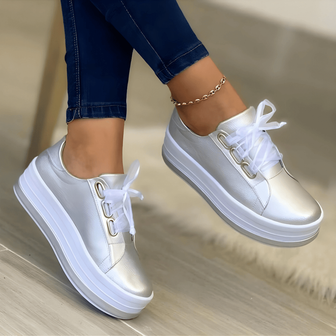 Fashionable gold women's platform sneakers, combining style and comfort with a high sole design.