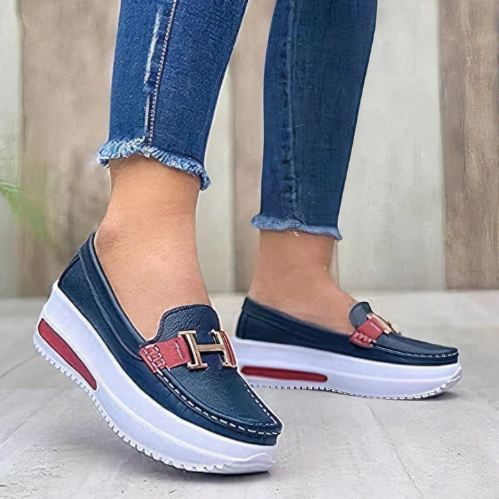 Black women's platform loafers with a chunky sole. Easy slip-on design, providing comfort and modern style for any outfit.