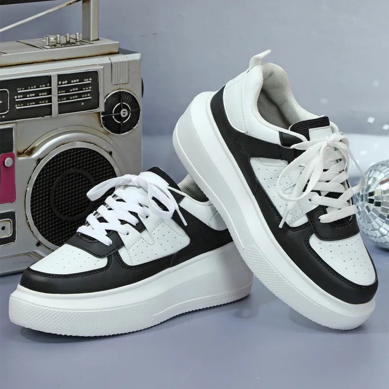 White women's platform sneakers featuring stylish perforated panels & durable laces. Casual trendy footwear.