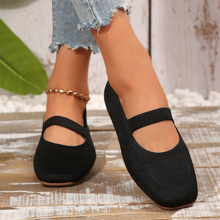 Red women's playful Mary Jane ballet flats with an adjustable strap and smiling face, great for unique casual style.