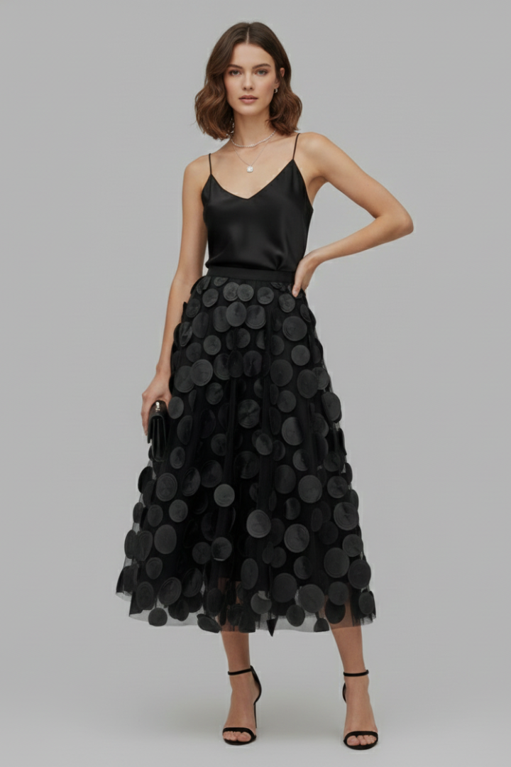 Close-up: playful white polka dots on a stylish women's full midi skirt. Fashionable & elegant.