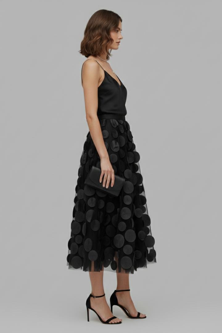 Woman modeling an elegant polka dot full midi skirt. Playful women's fashion, perfect for any occasion.