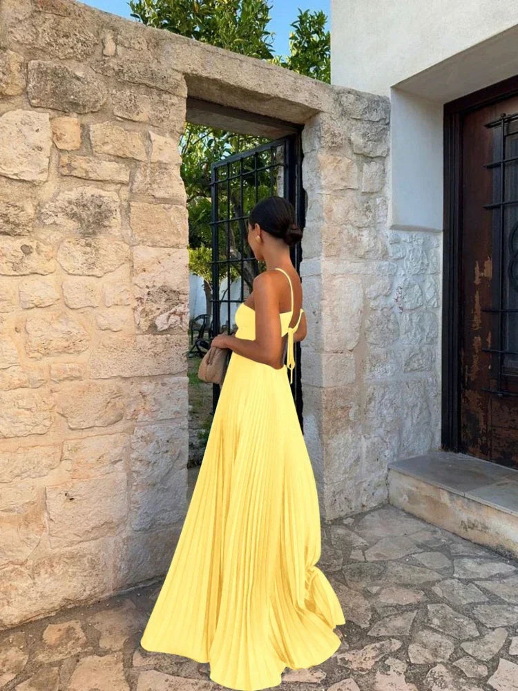 Women's elegant pleated halter maxi dress with cutout detail, perfect for special occasion evenings.