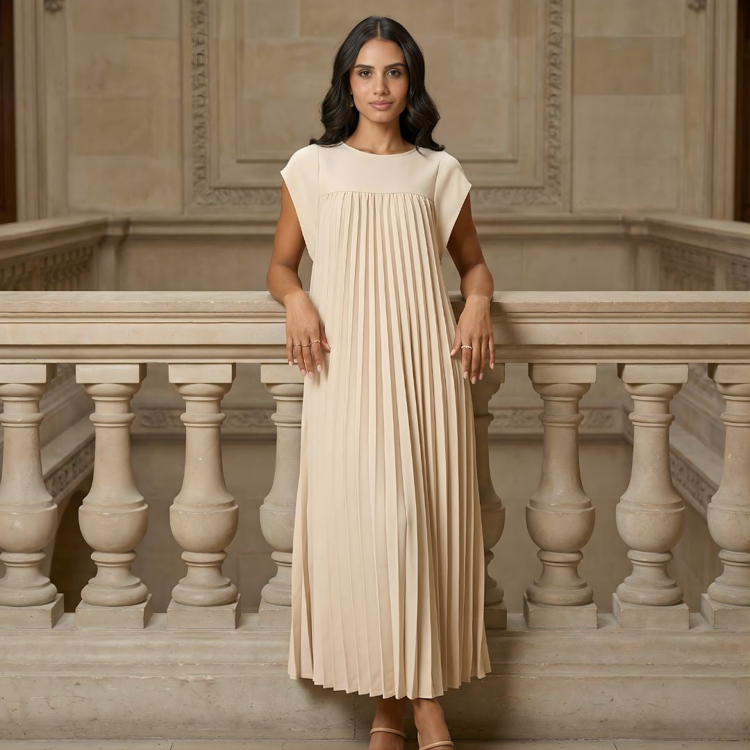 Women's pleated maxi dress with extended cap sleeves and relaxed empire waist.
