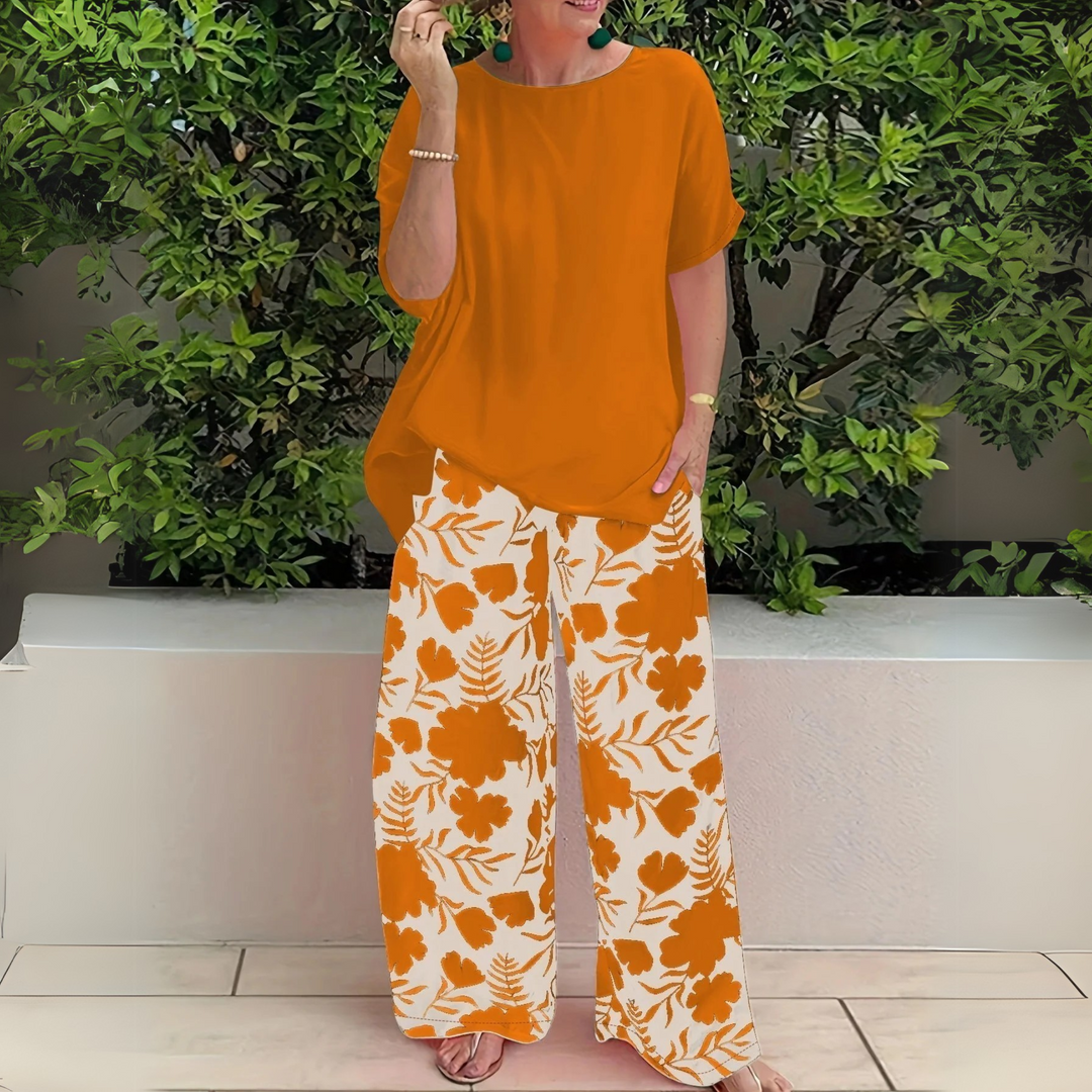 Elegant plus size women's floral two-piece outfit, featuring a stylish top & wide-leg pants for casual events.