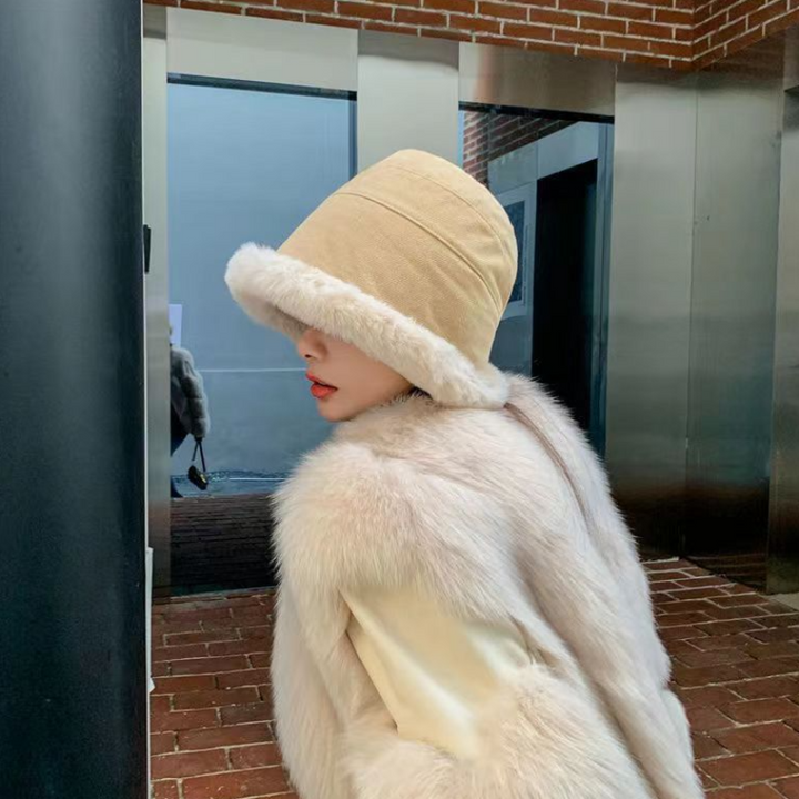 Stylish woman wearing a black plush velvet bucket hat, a chic and warm winter accessory