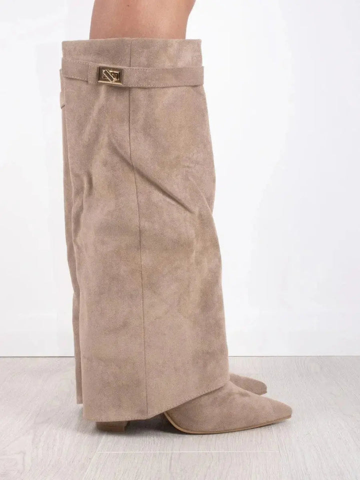 Close-up of pointed toe on women's wedge knee-high boots, elegant and sophisticated design.