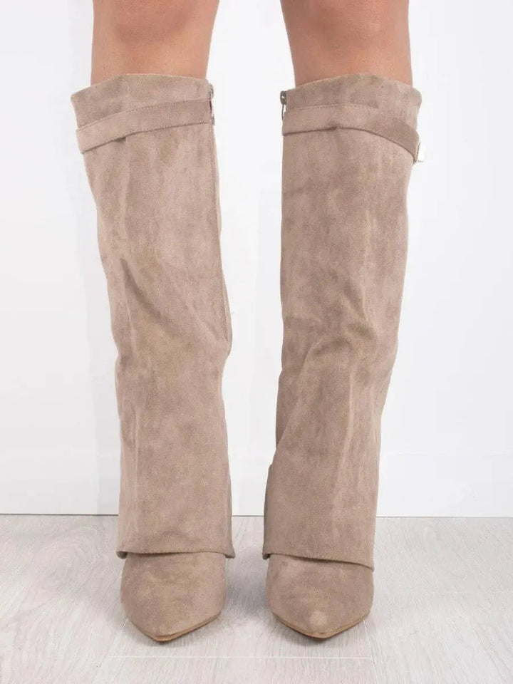 Close-up of the comfortable wedge heel on women's knee-high boots, stylish and supportive.