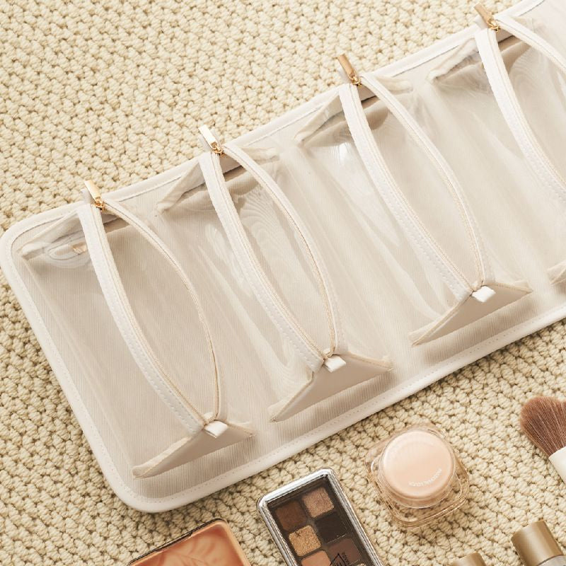 Detachable sections of a women's cosmetic bag, showing individual pouches for makeup organization