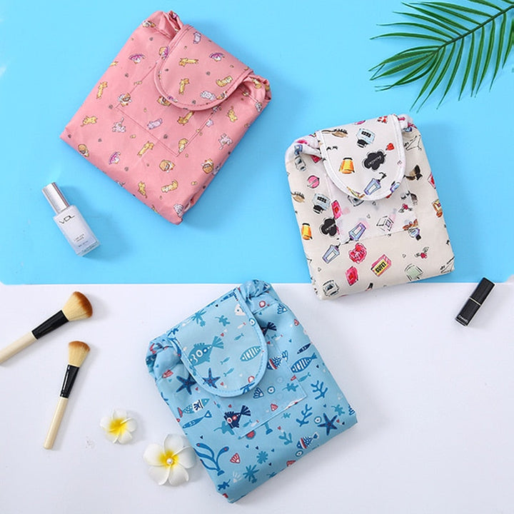 Set of two portable drawstring cosmetic bags for women, black and pink, versatile travel organizers.