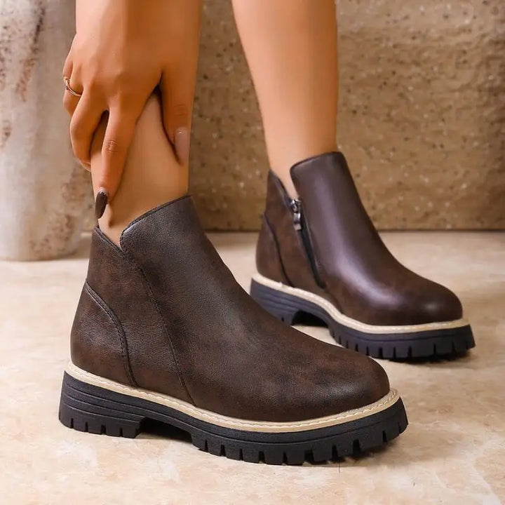 Women's premium black leather ankle boots with lug sole, perfect for fall fashion and winter footwear.