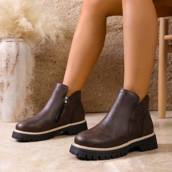Stylish women's leather ankle boots featuring a comfortable lug sole and convenient side zip closure.