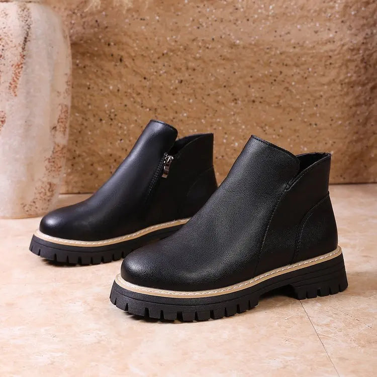 Fashionable women's winter boots: black leather ankle boots with a practical side zip and trendy lug sole.