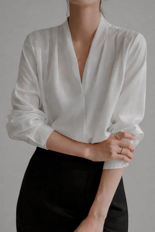 Women's refined everyday wrap blouse, perfect for versatile styling. Elegant long sleeve top for work or casual chic.