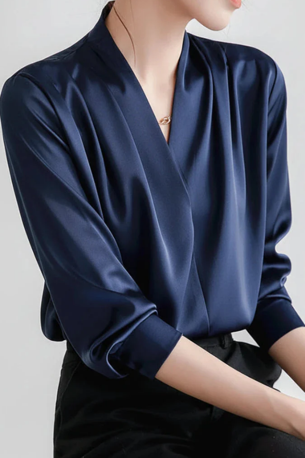 Fashionable women's elegant wrap blouse. Sophisticated long sleeve top, ideal for stylish women's everyday clothing.