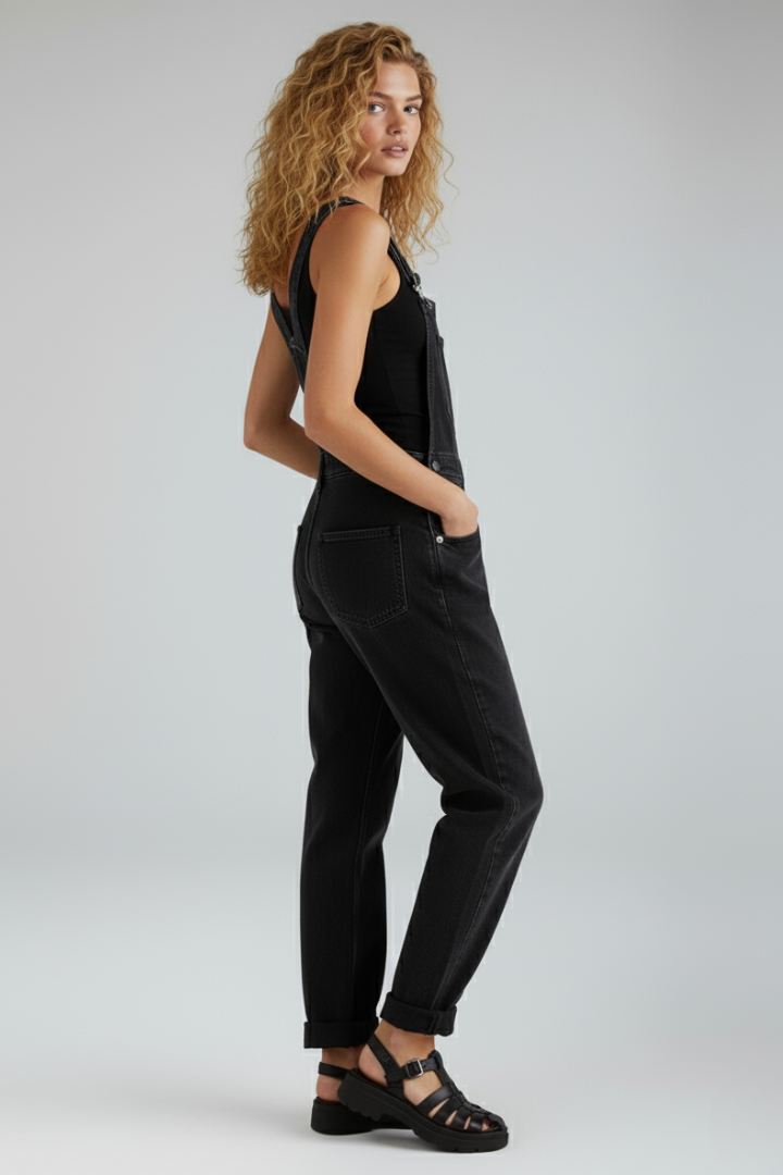 Versatile black one-piece women's jumpsuit with a relaxed fit, straight leg, and convenient side pockets for comfort.
