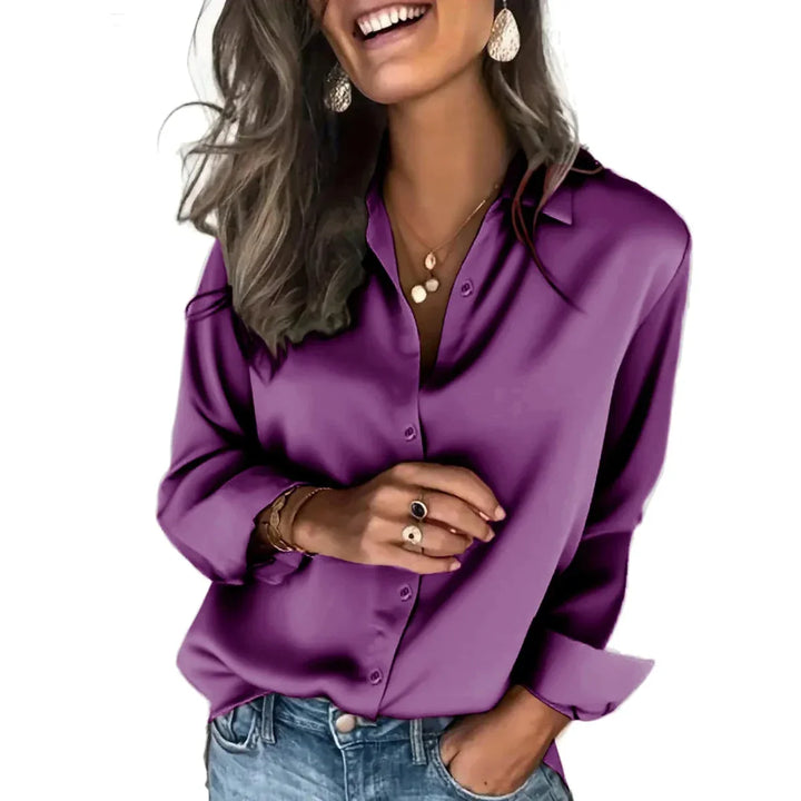 Folded stack of women's relaxed button-down shirts, long sleeve, for versatile everyday styling.