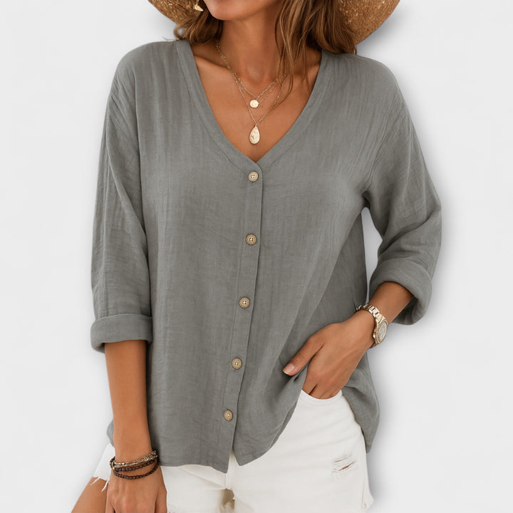 Comfortable women's relaxed fit button-up shirt. Chic V-neck long sleeve, versatile for everyday or office.
