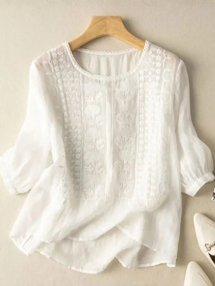 Women's relaxed fit embroidered blouse with elegant floral details, perfect for spring casual wear.