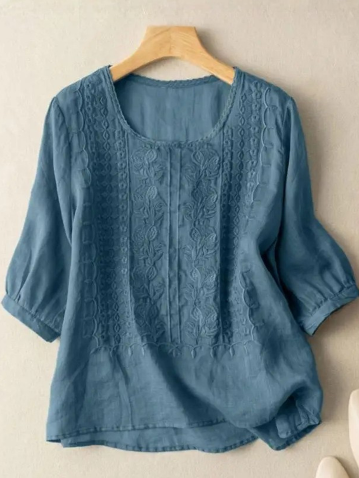Comfortable women's relaxed fit blouse featuring three-quarter sleeves and delicate embroidery for summer style.