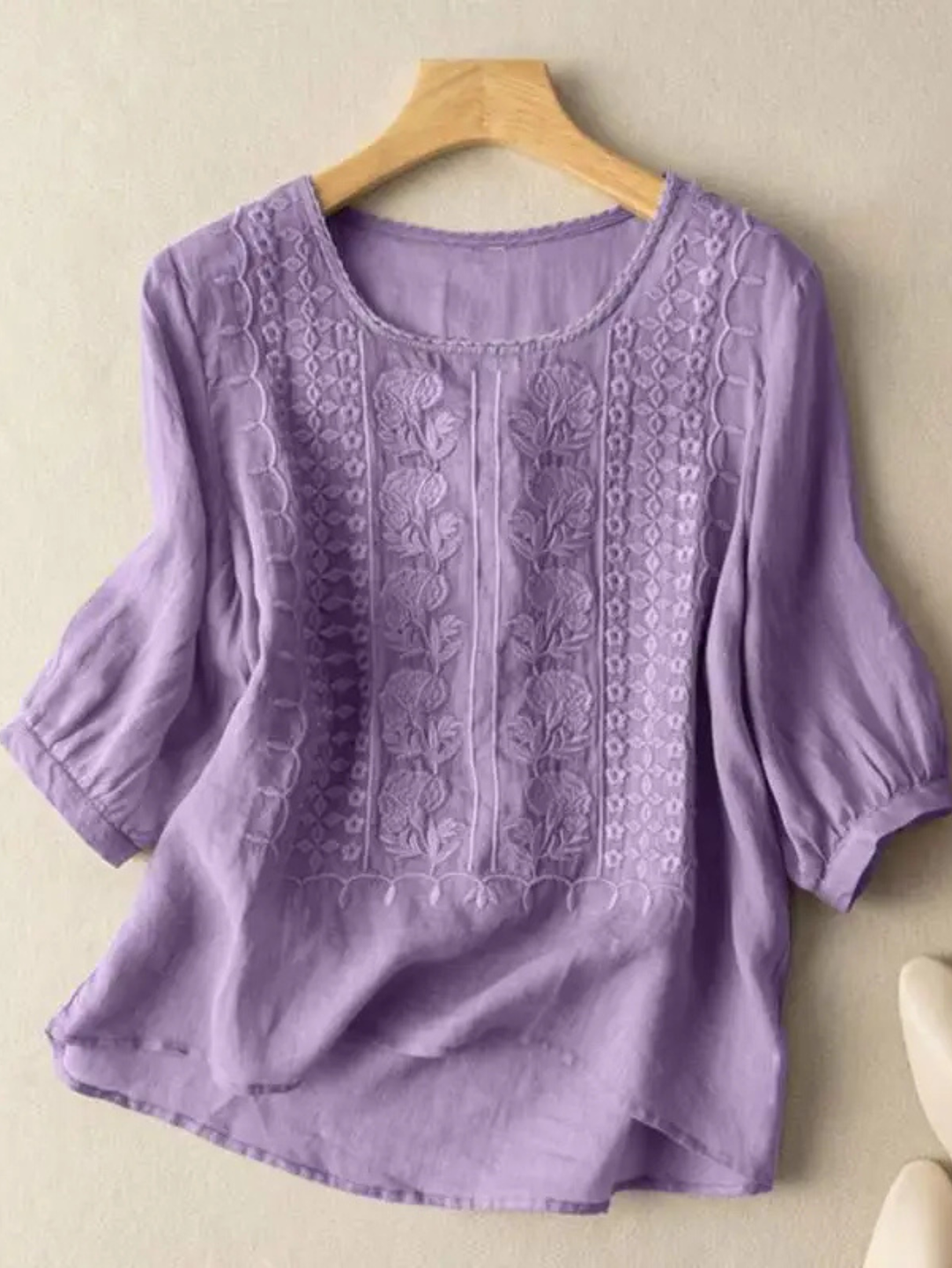 Stylish women's relaxed fit blouse with intricate embroidery and comfortable three-quarter sleeves for spring/summer.