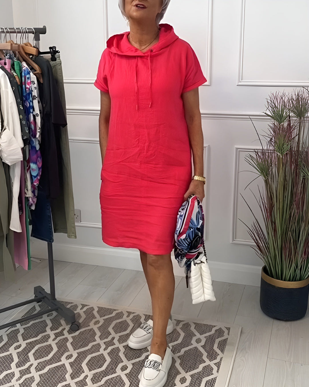 Stylish women's relaxed fit hoodie dress, midi length, half sleeve, and adjustable hood for comfort.