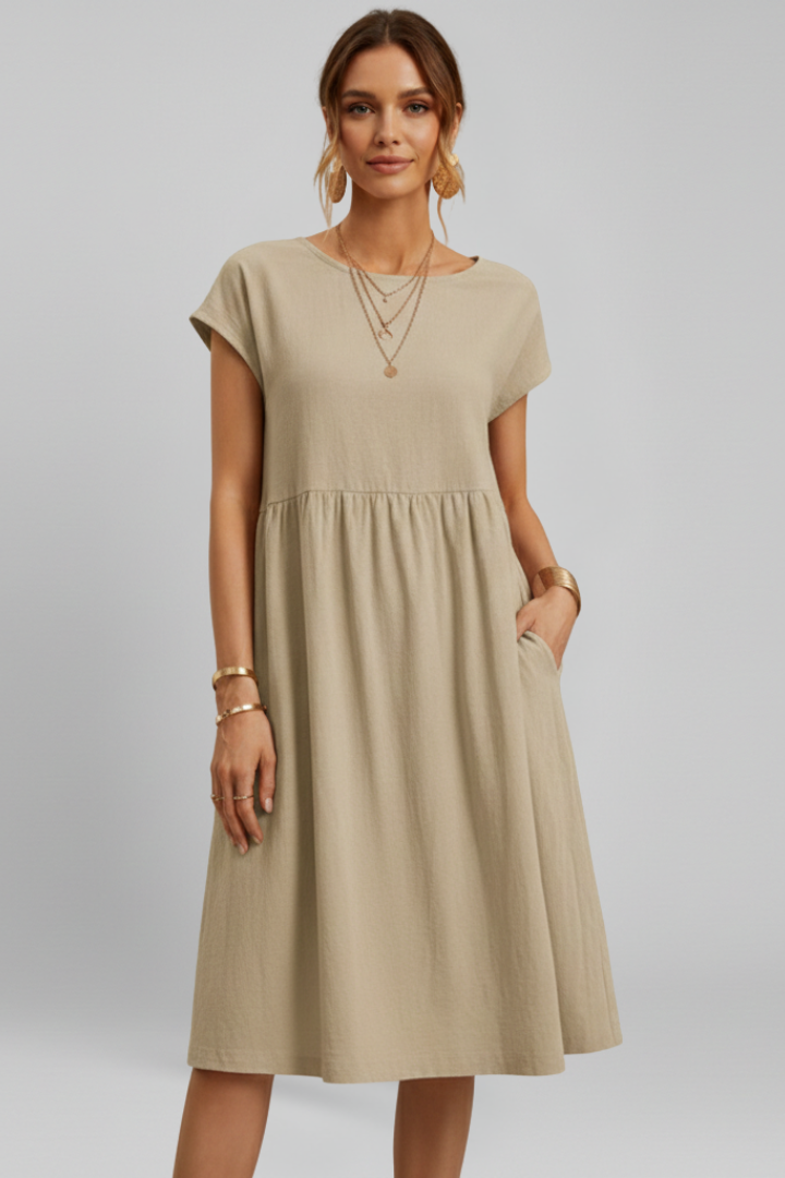 Comfortable women's knee-length dress, relaxed fit with round neck, short sleeves & practical pockets.