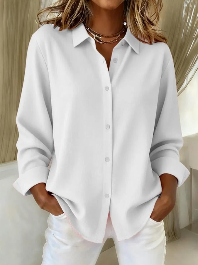 Elegant women's long sleeve button down blouse. Relaxed fit offers versatile style for office or casual outings.