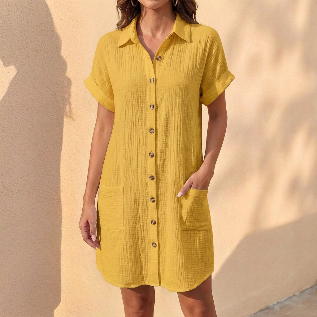 Detail shot: Button-front closure, collared neckline, & cuffed sleeves on a women's relaxed fit midi shirt dress.