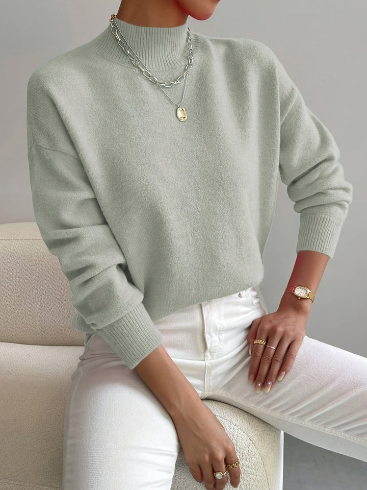 Women's relaxed fit mock turtleneck long sleeve sweater, cozy knit for casual autumn/winter style.