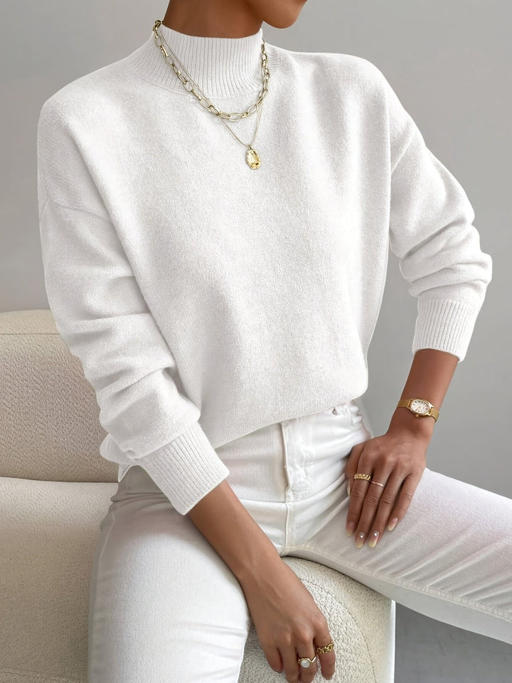 Chic women's relaxed fit mock turtleneck long sleeve sweater, perfect for smart casual autumn outfits.