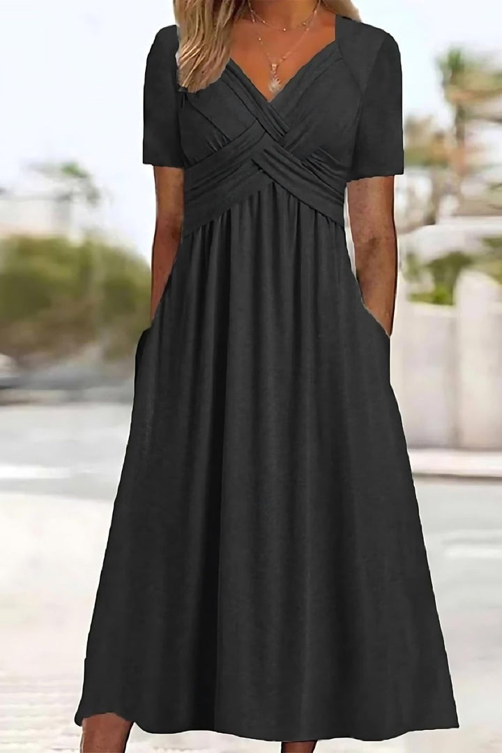 Model wears a comfortable women's relaxed fit printed midi dress, an effortless style for everyday spring/summer.