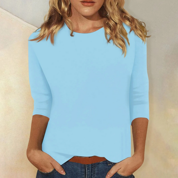 Black minimalist women's 3/4 sleeve top. Relaxed fit, round neck, perfect for versatile casual wear.