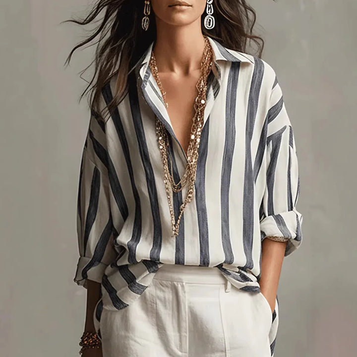 Women's relaxed fit striped button-down shirt. Long-sleeve collared top, perfect for casual everyday style.
