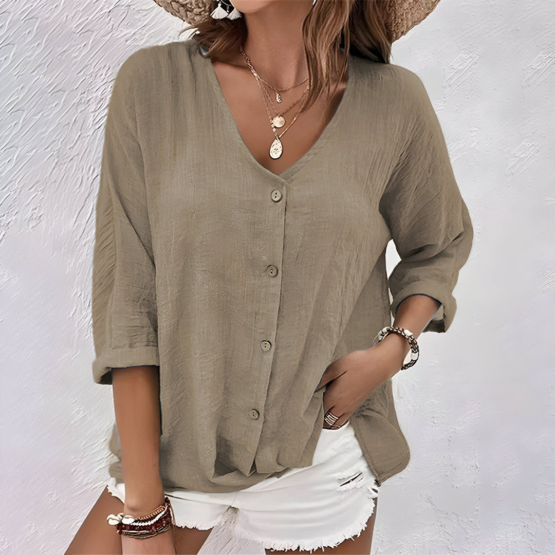 Versatile women's V-neck button-up blouse with long sleeves & relaxed fit. Great for workwear or casual outfits.