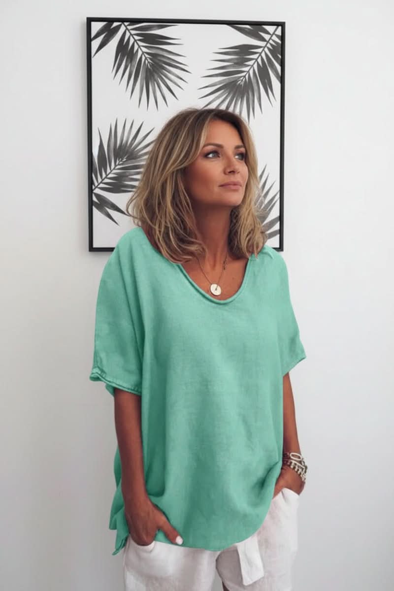Lightweight women's summer blouse, V-neck, and relaxed fit for breathable, stylish warm weather wear.